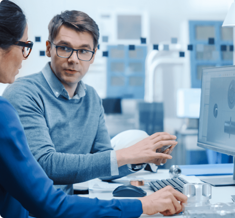 Two professionals collaborating on custom software development